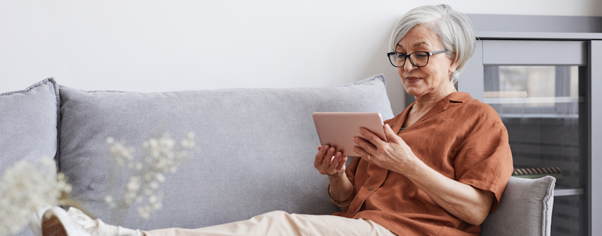Life Assure Senior Woman Relaxing With iPad Tablet Hero